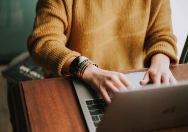 a person typing on a laptop