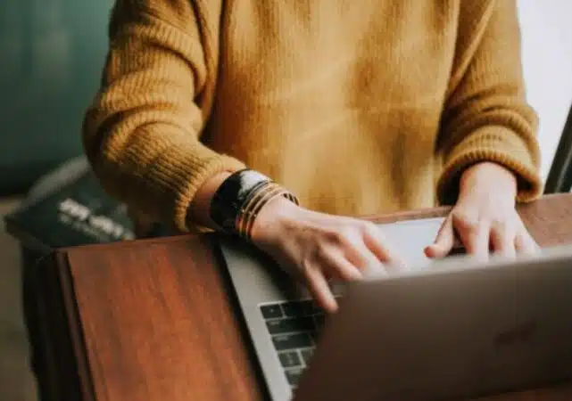 a person typing on a laptop