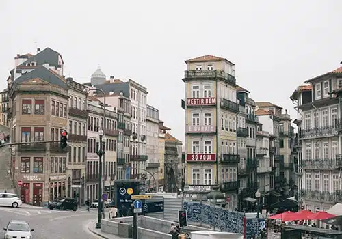 streets of baixa in porto during the day with cars