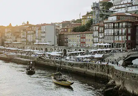 river with boats near a road in portugal