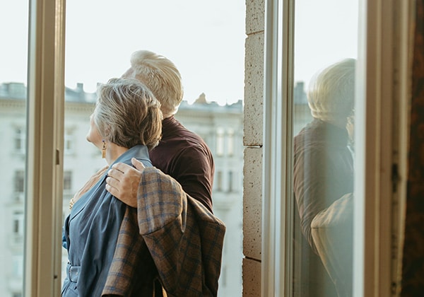 a retired couple looking at a window
