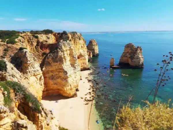 the cliffs of Lagos near water with blue sky