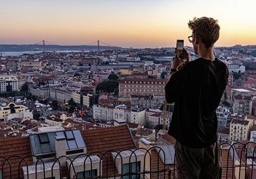 person taking a picture in one of lisbon miradouros