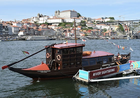 boat on the douro river in porto for the bridges cruise