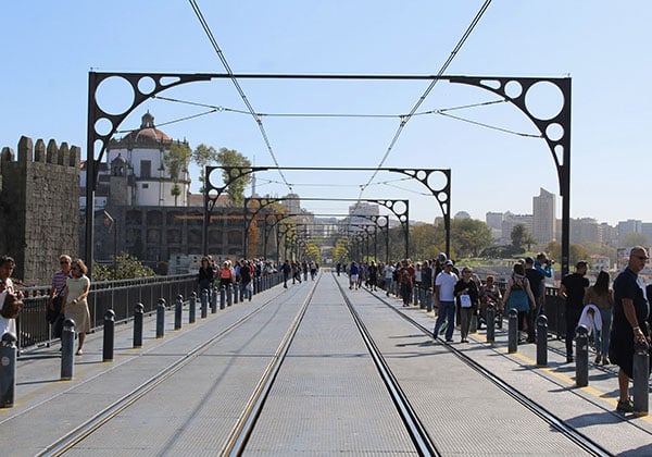 people crossing the d luis bridge in porto