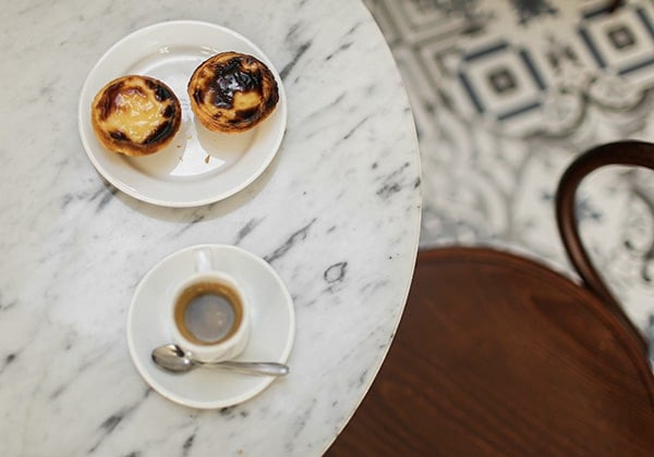pastel de nata and a coffee in a cafe table