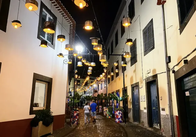 People walking a street in Camara de Lobos, Madeira